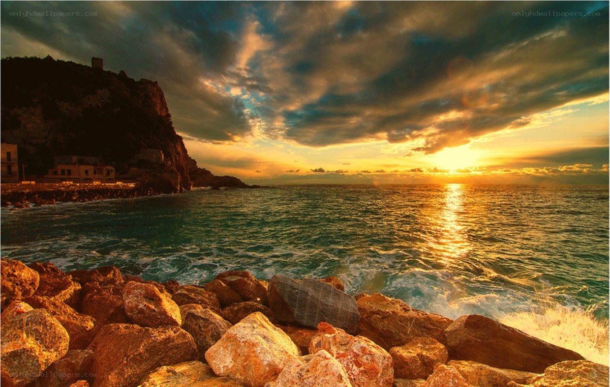 Sunset over rocky coastline