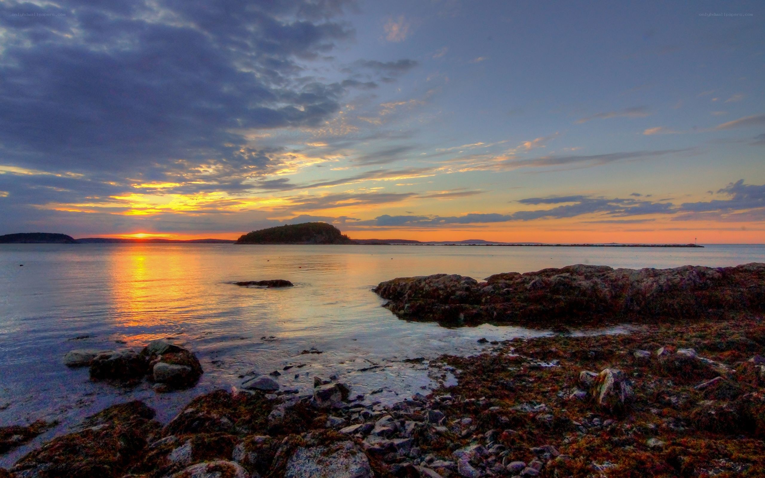 sunset over rocky coastline