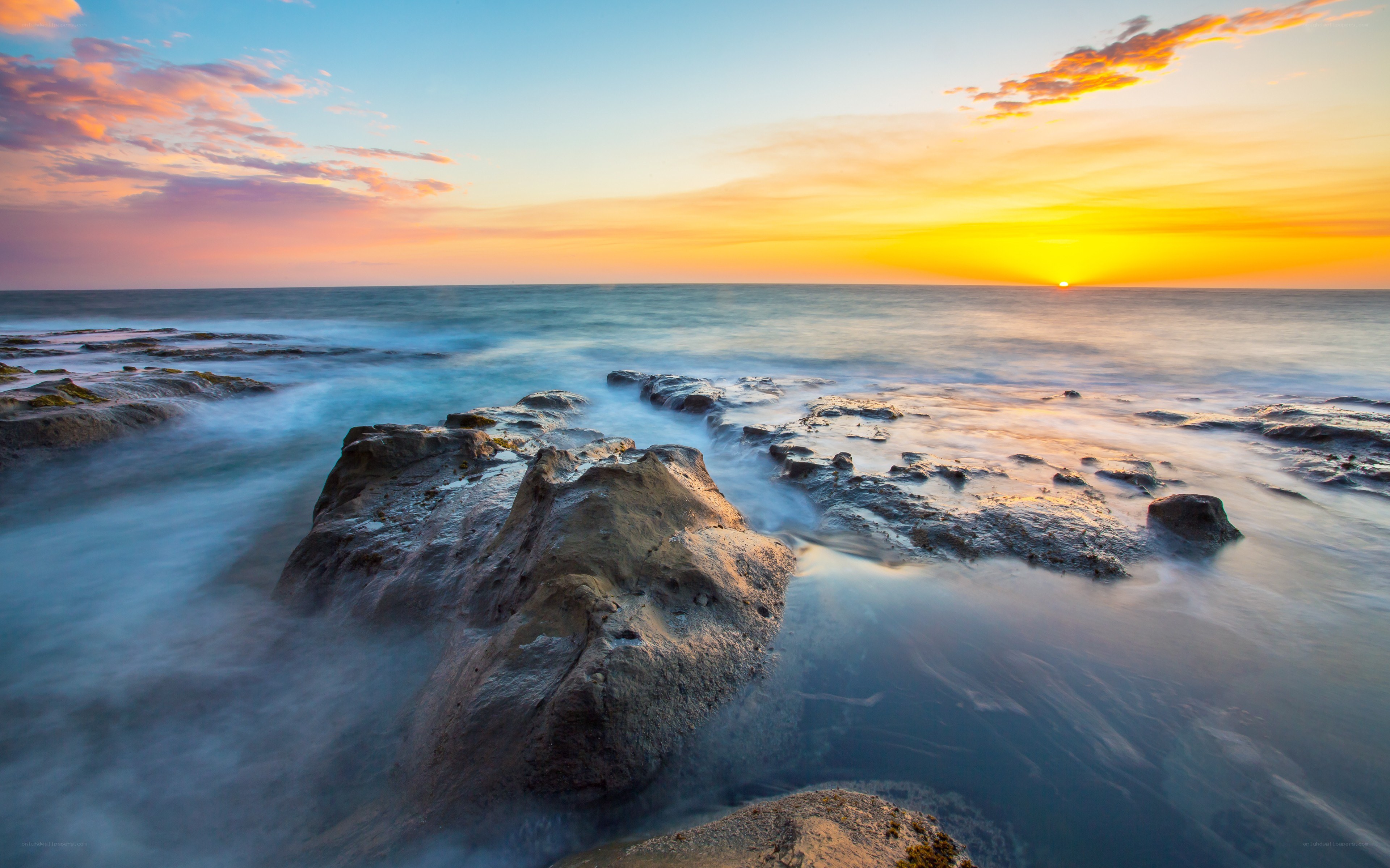 Sunset over rocky coastline