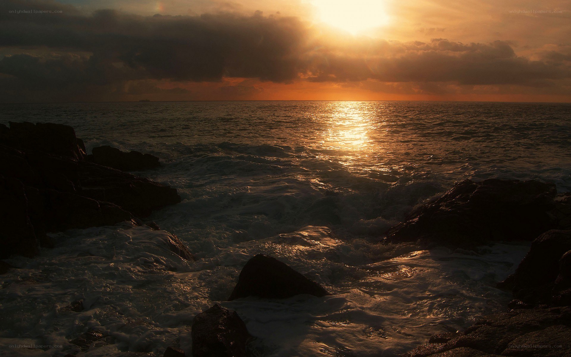 Sunset over rocky coastline