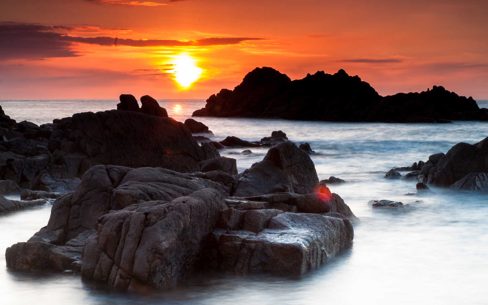 Sunset over rocky coastline