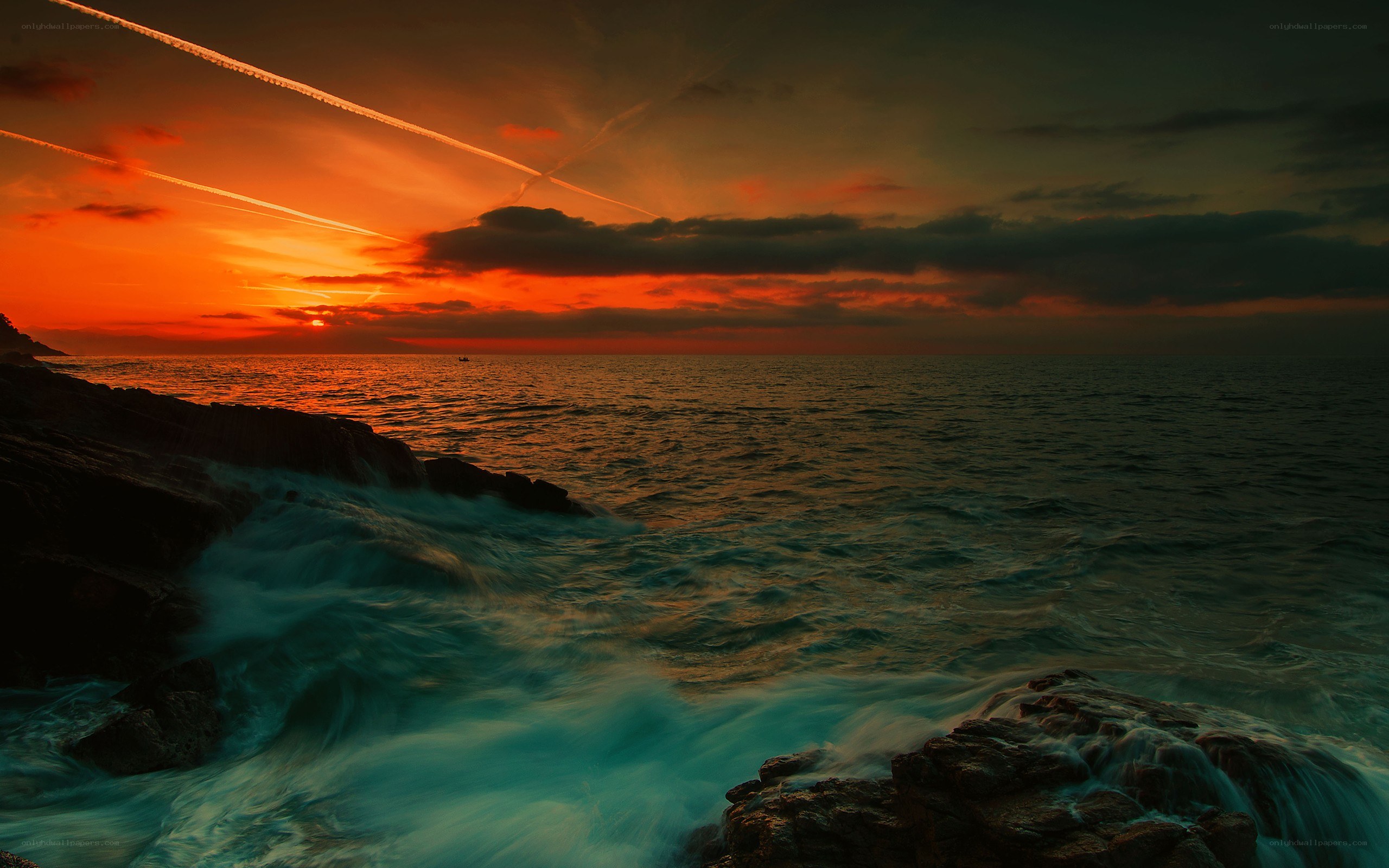 Sunset over rocky coastline