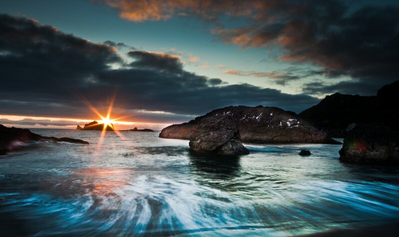 Sunset over rocky coastline