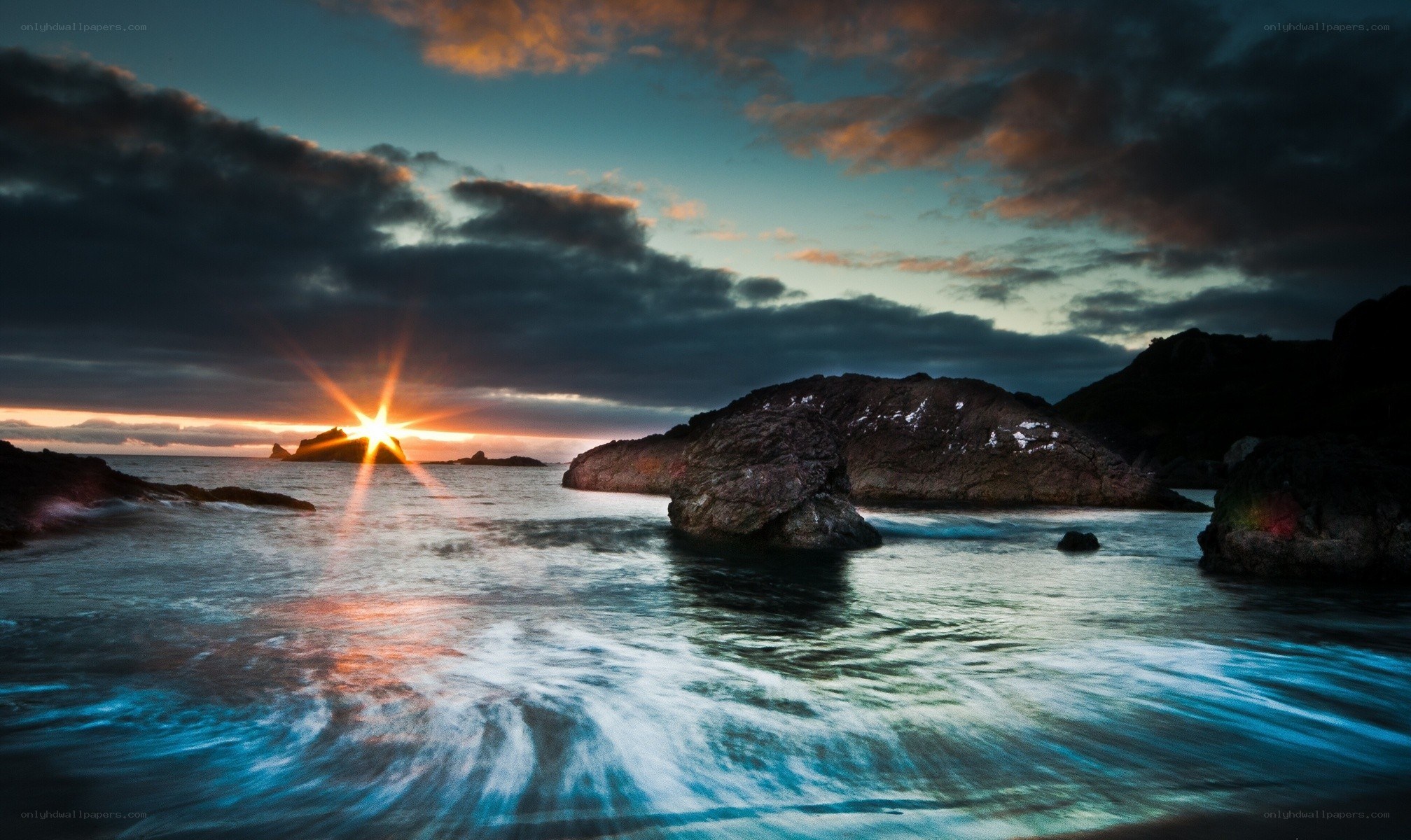 Sunset over rocky coastline
