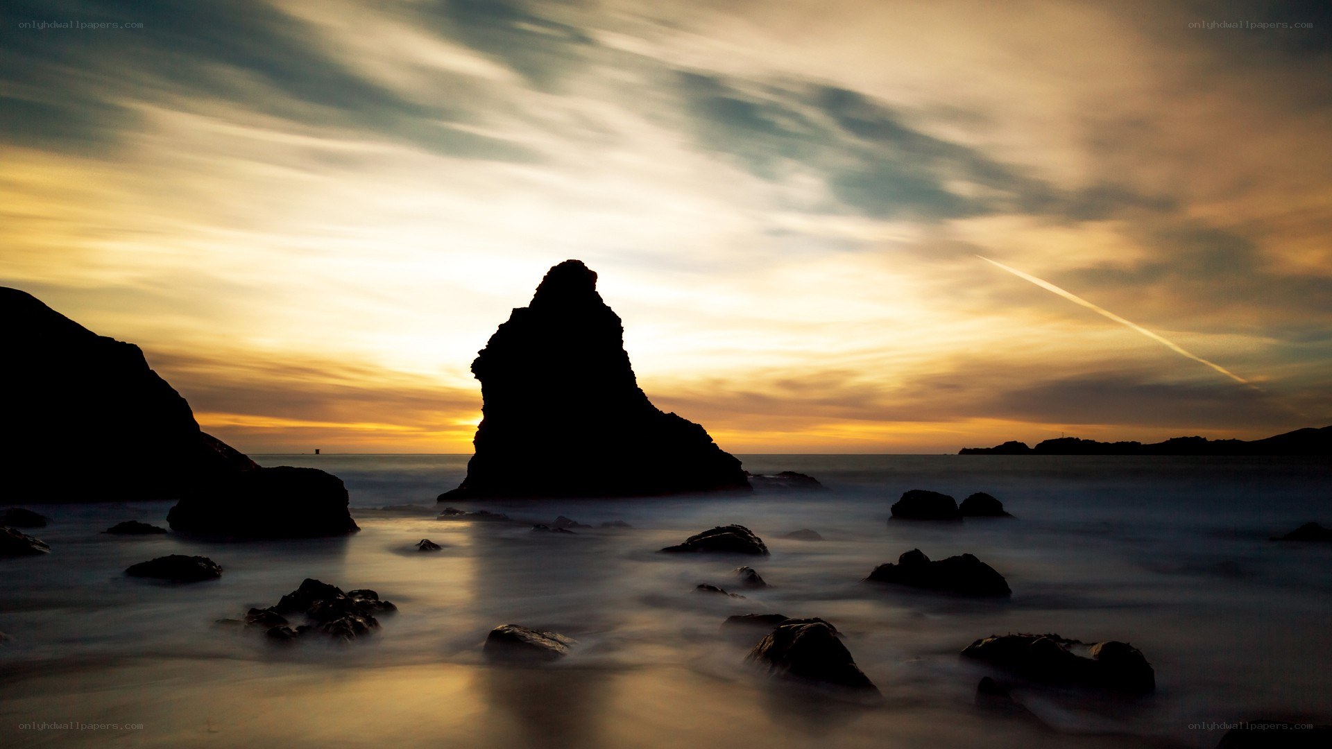 Sunset over rocky coastline