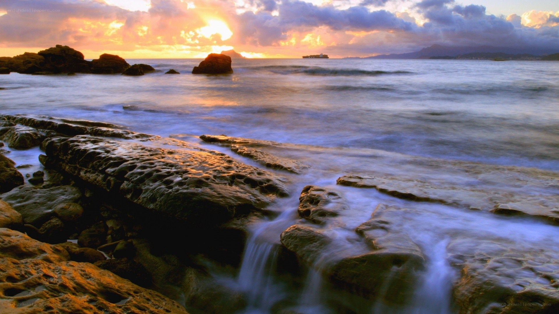 Sunset over rocky coastline