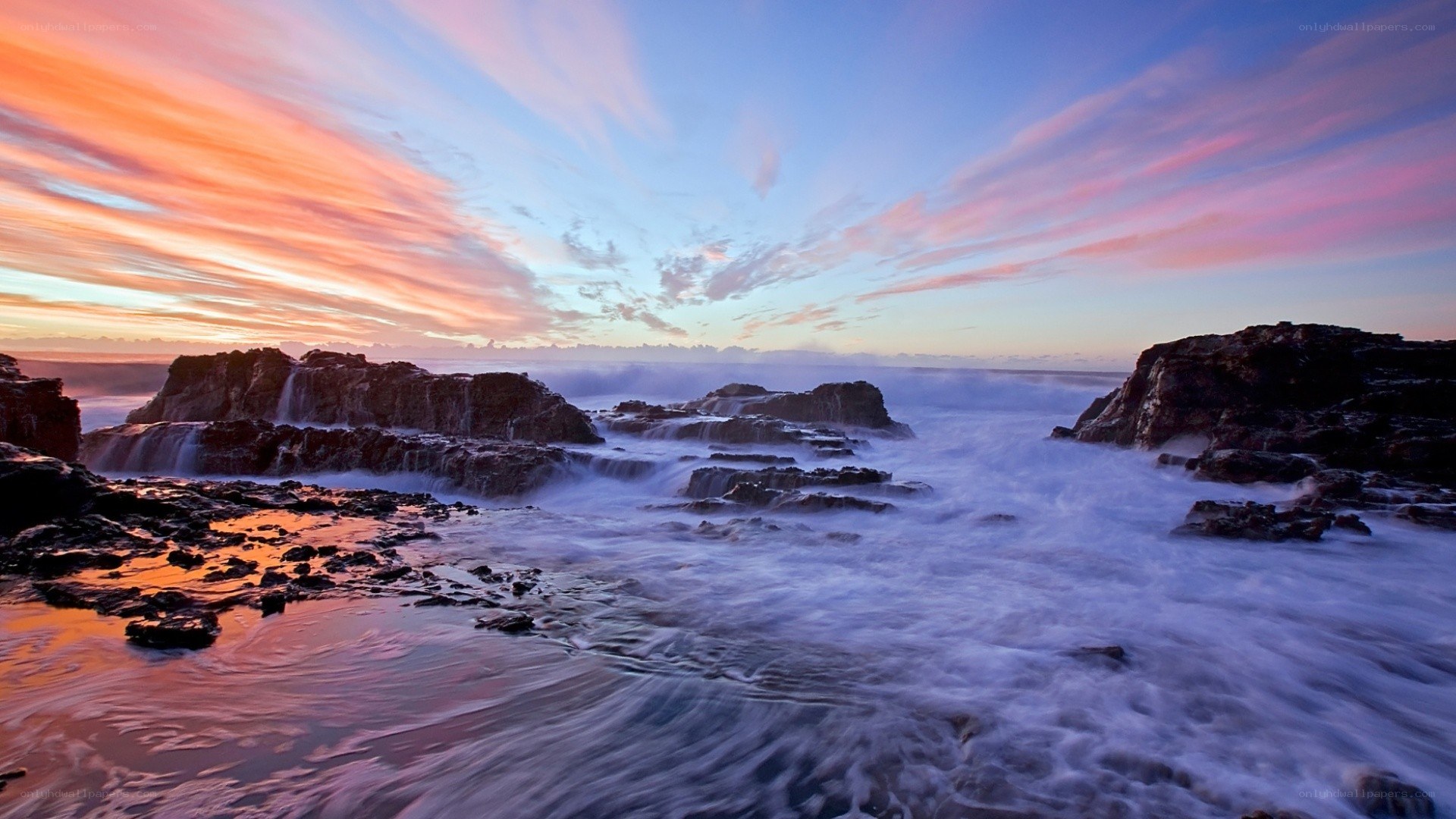 Sunset over rocky coastline