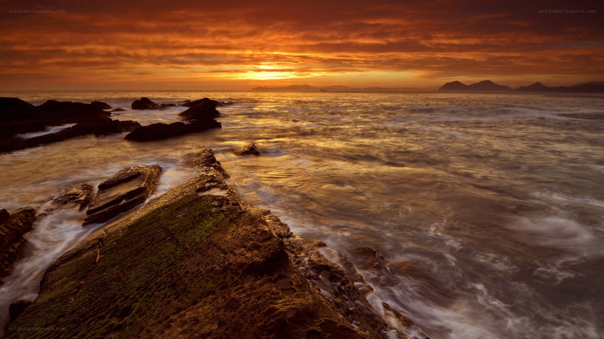 Sunset over rocky coastline