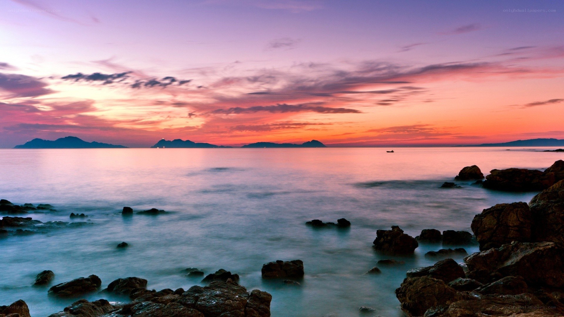 Sunset over rocky coastline