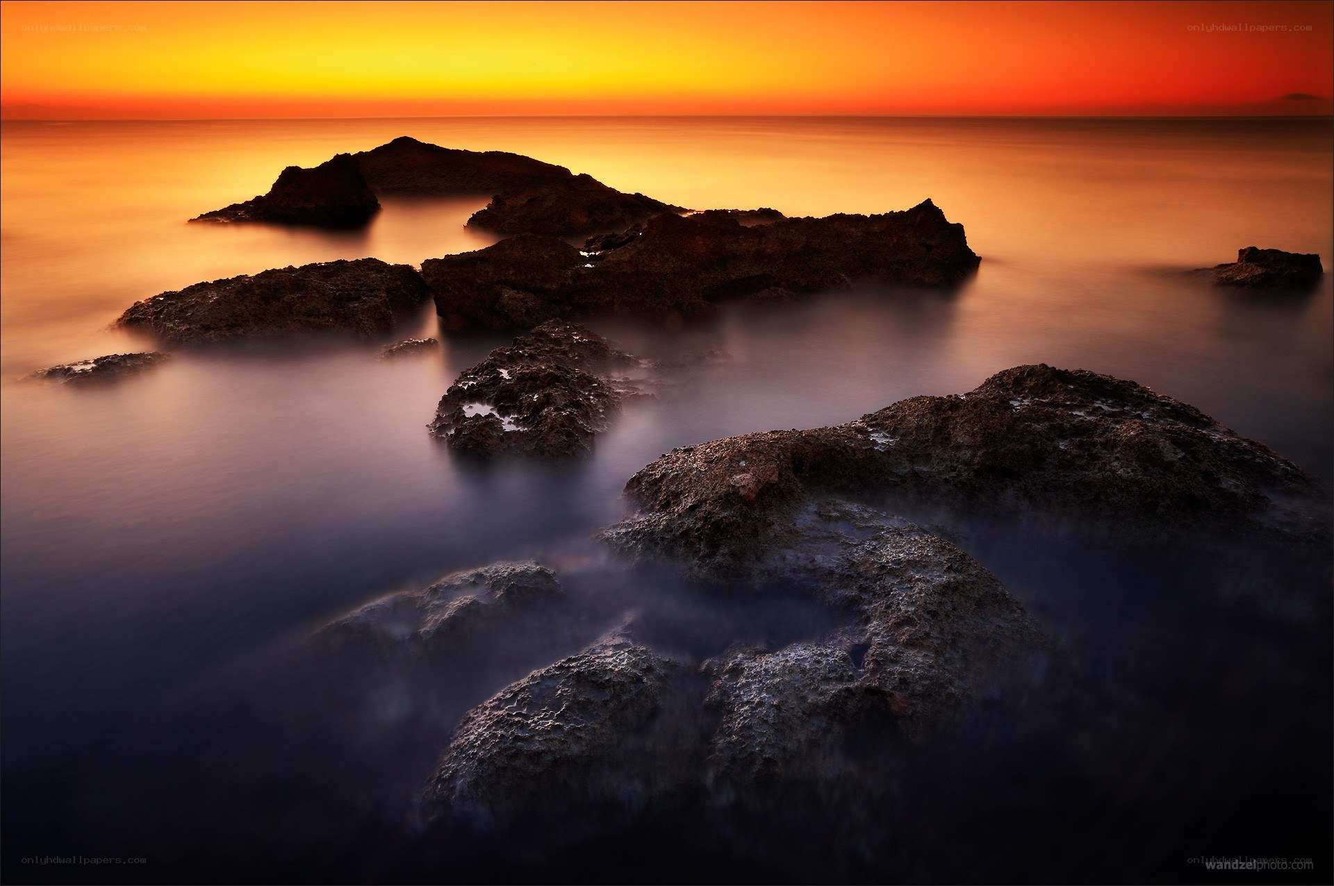 Sunset over rocky coastline