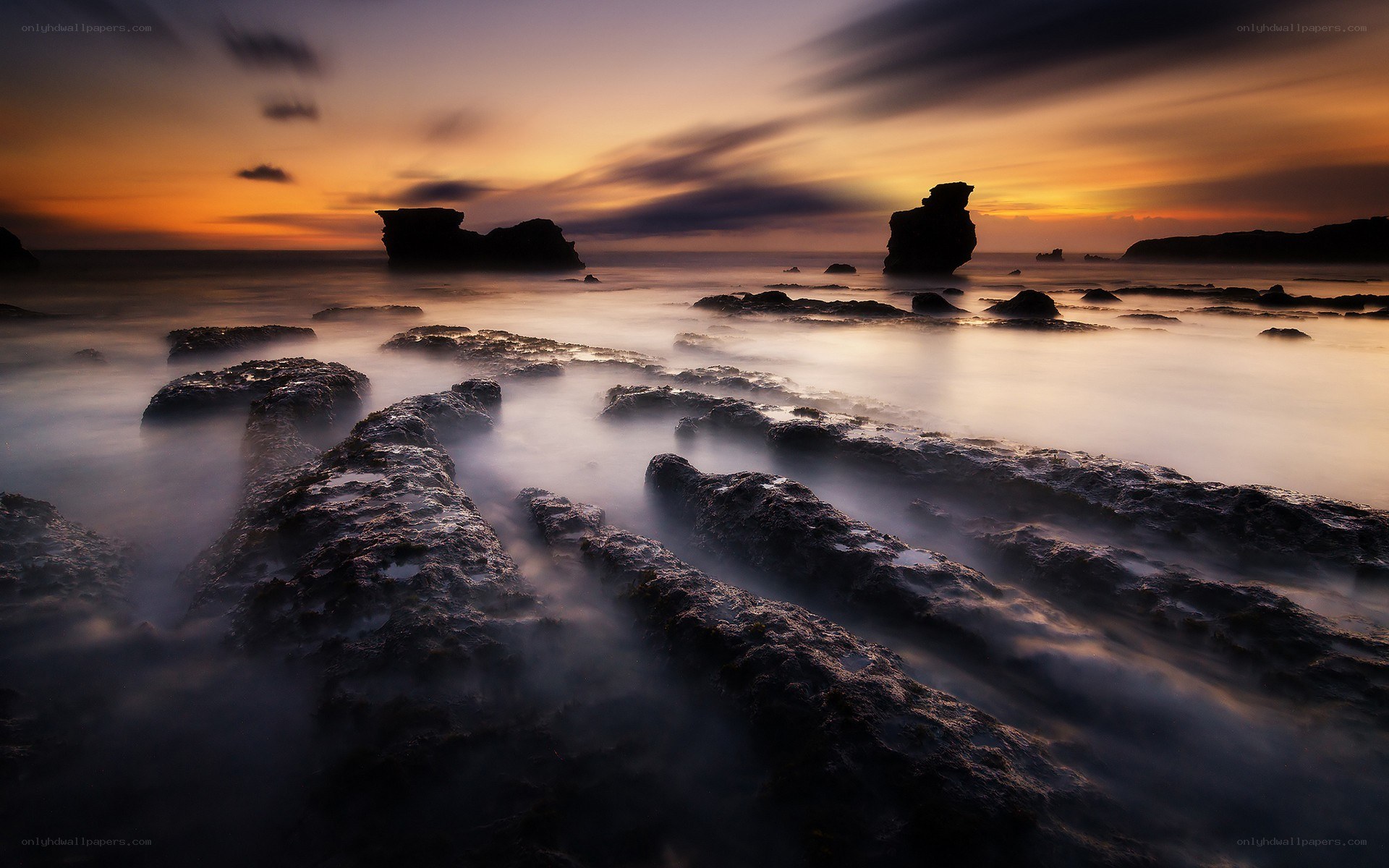 Sunset over rocky coastline