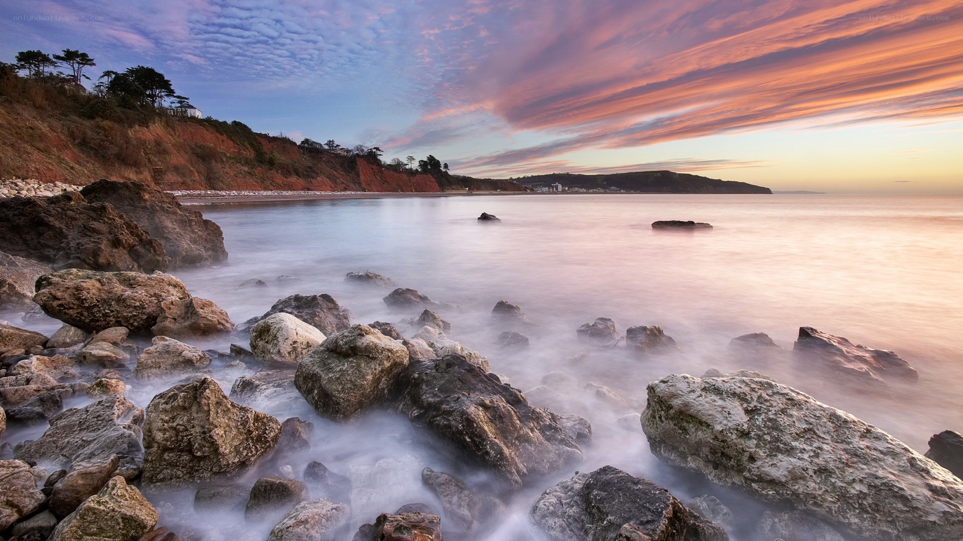 Sunset over rocky coastline