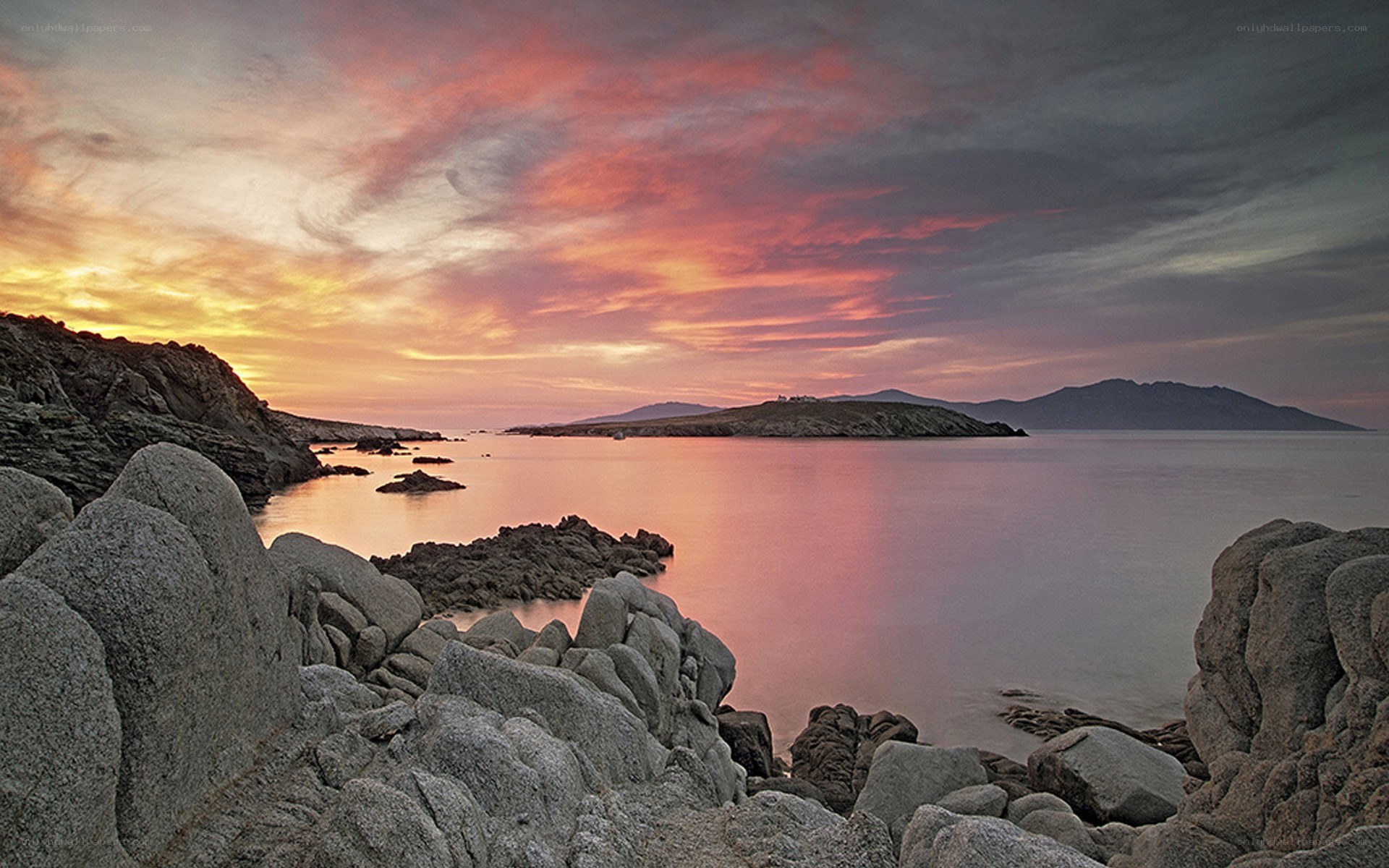 Sunset over rocky coastline
