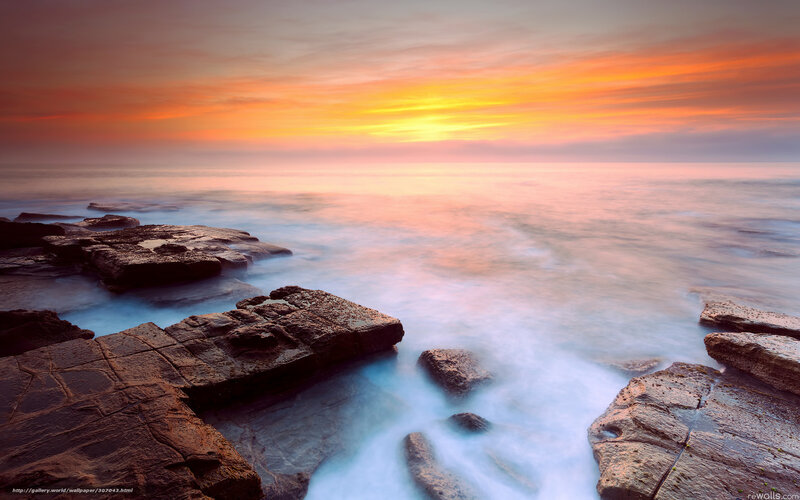 Sunset over rocky coastline