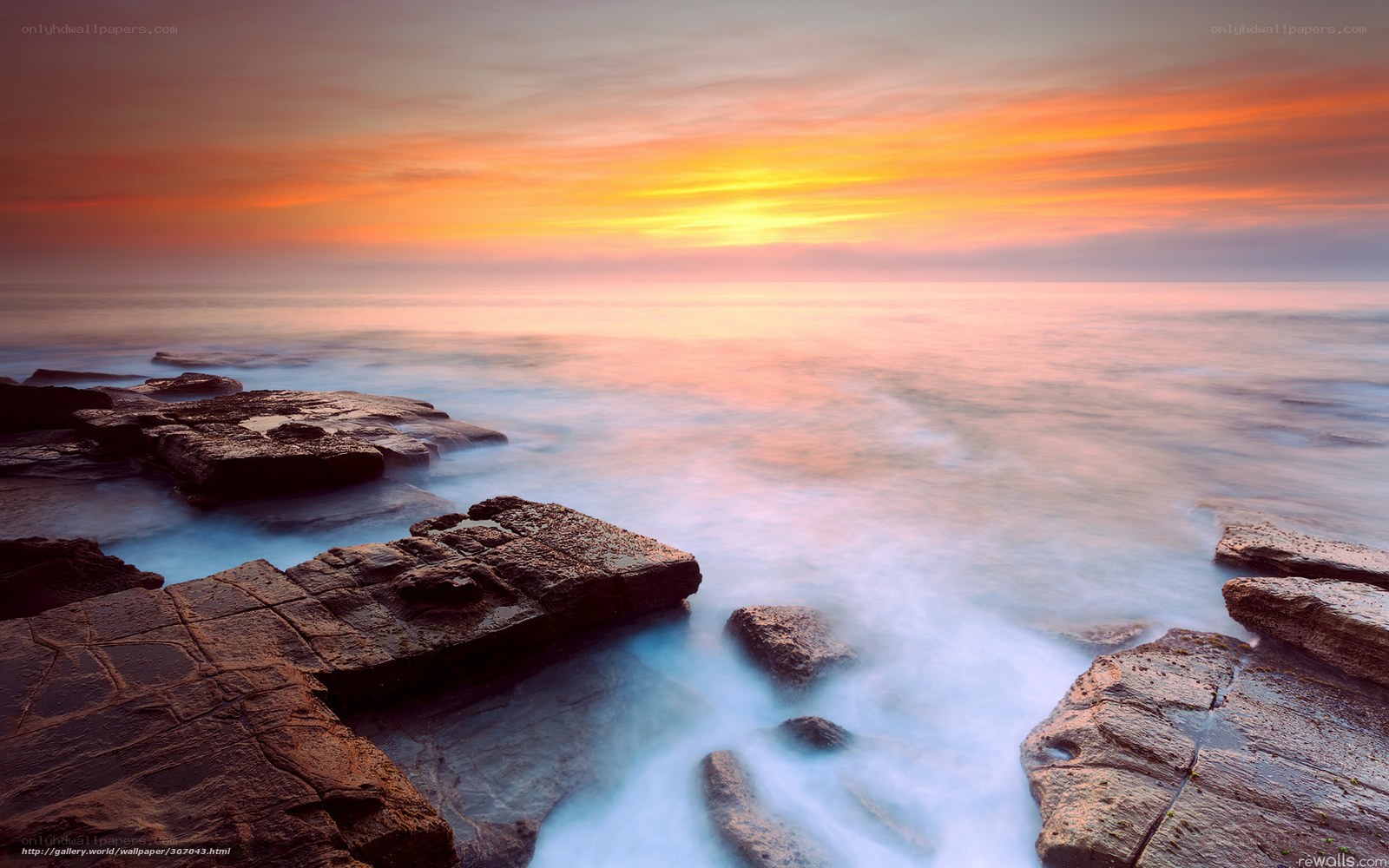 Sunset over rocky coastline