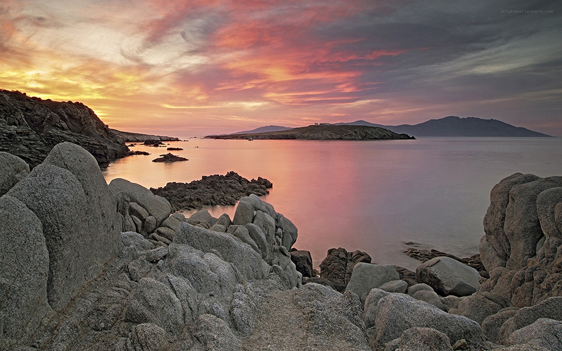 Sunset over rocky coastline