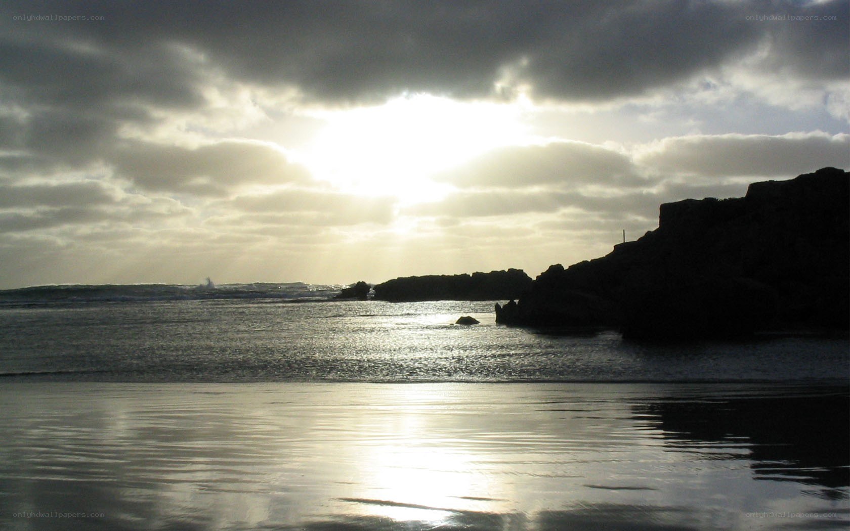 Sunset over rocky coastline