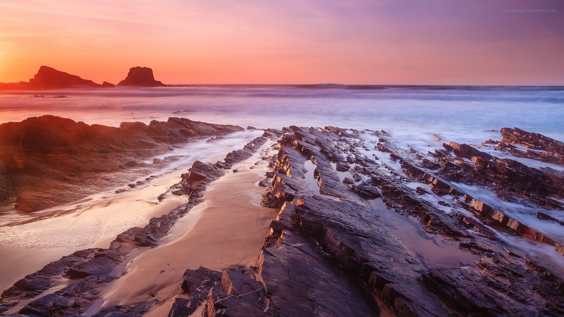 Sunset over rocky coastline