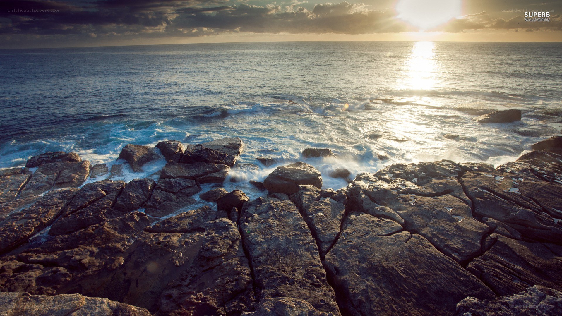 Sunset over rocky coastline
