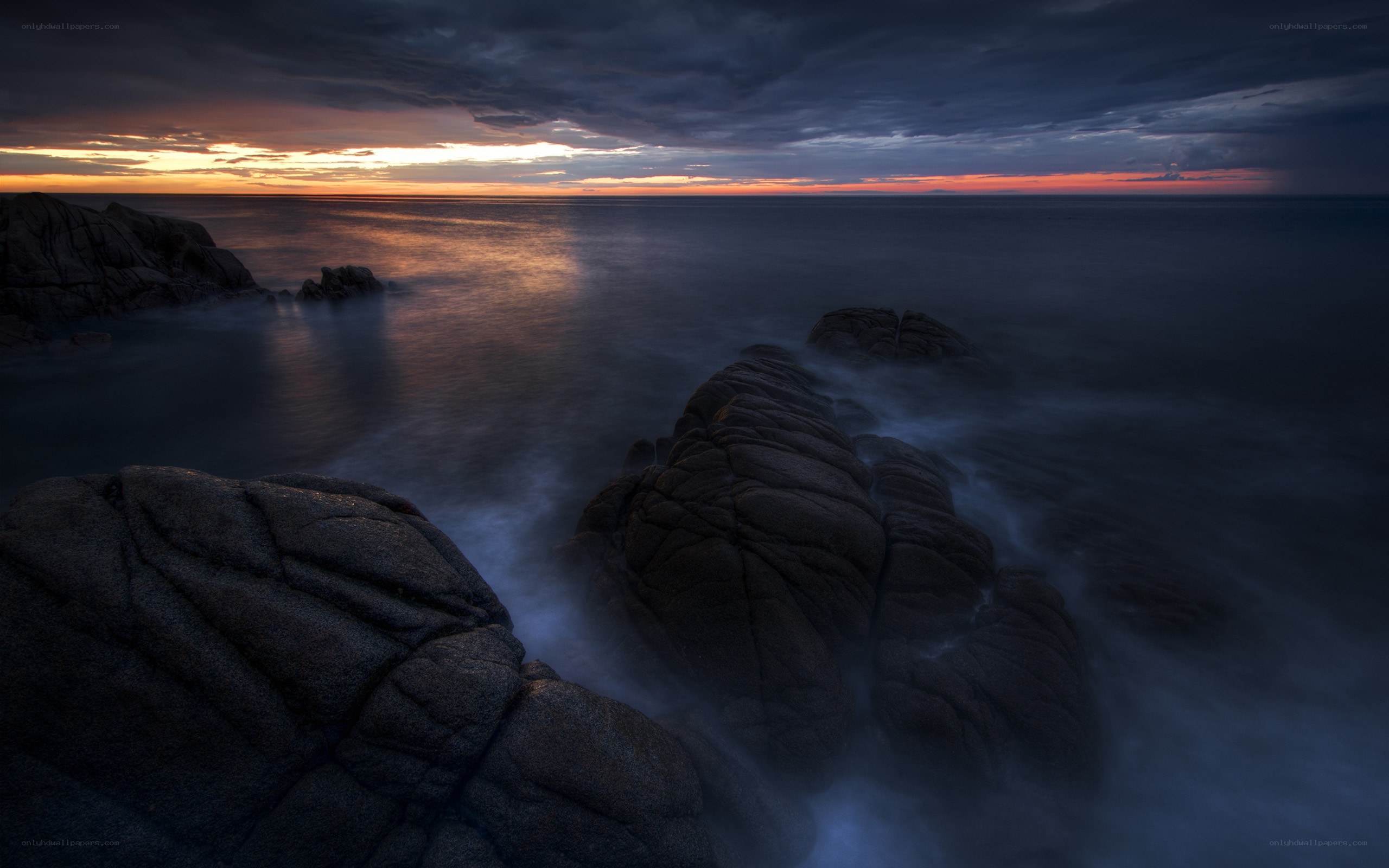 Sunset over rocky coastline