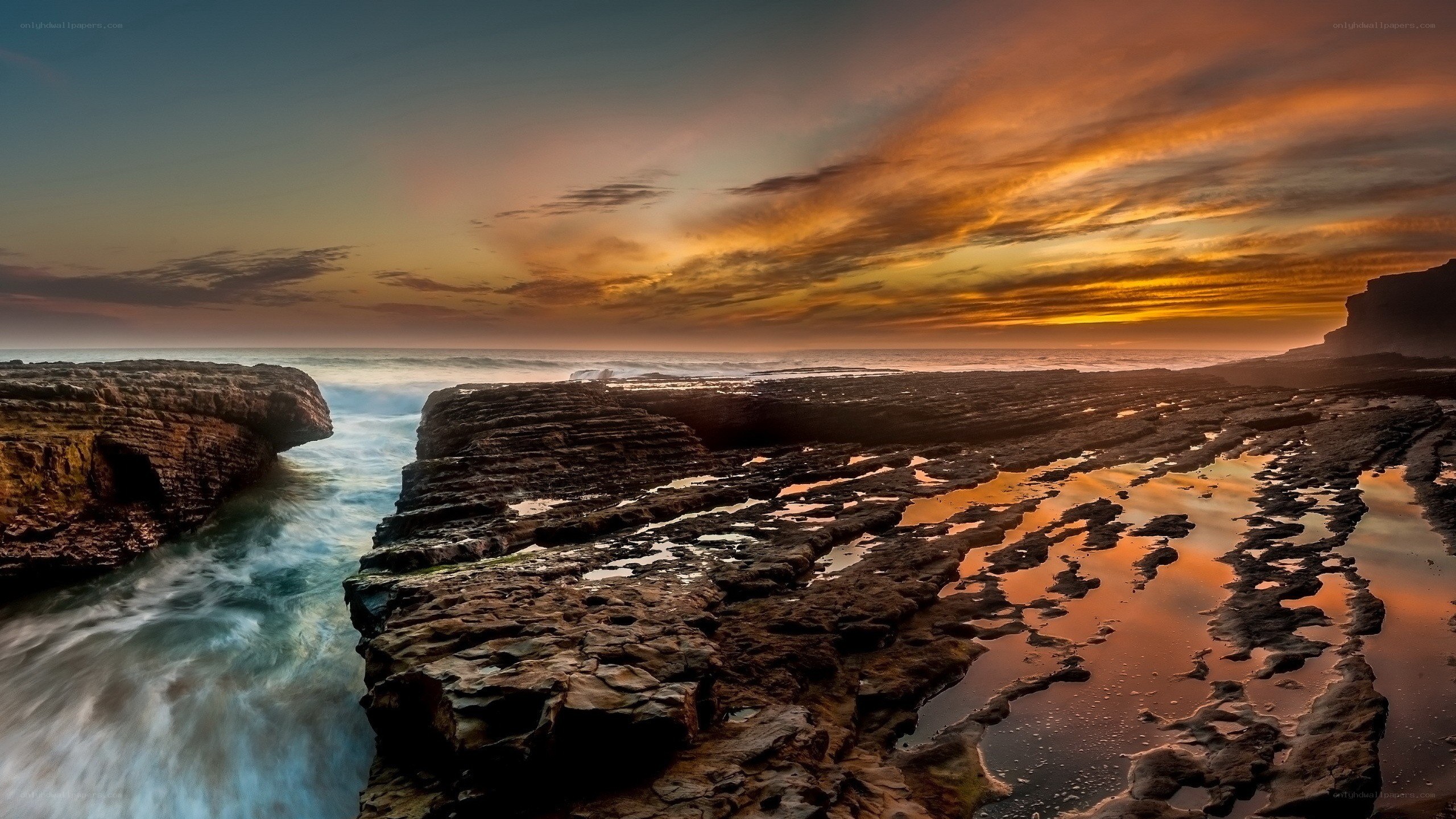 Sunset over rocky coastline
