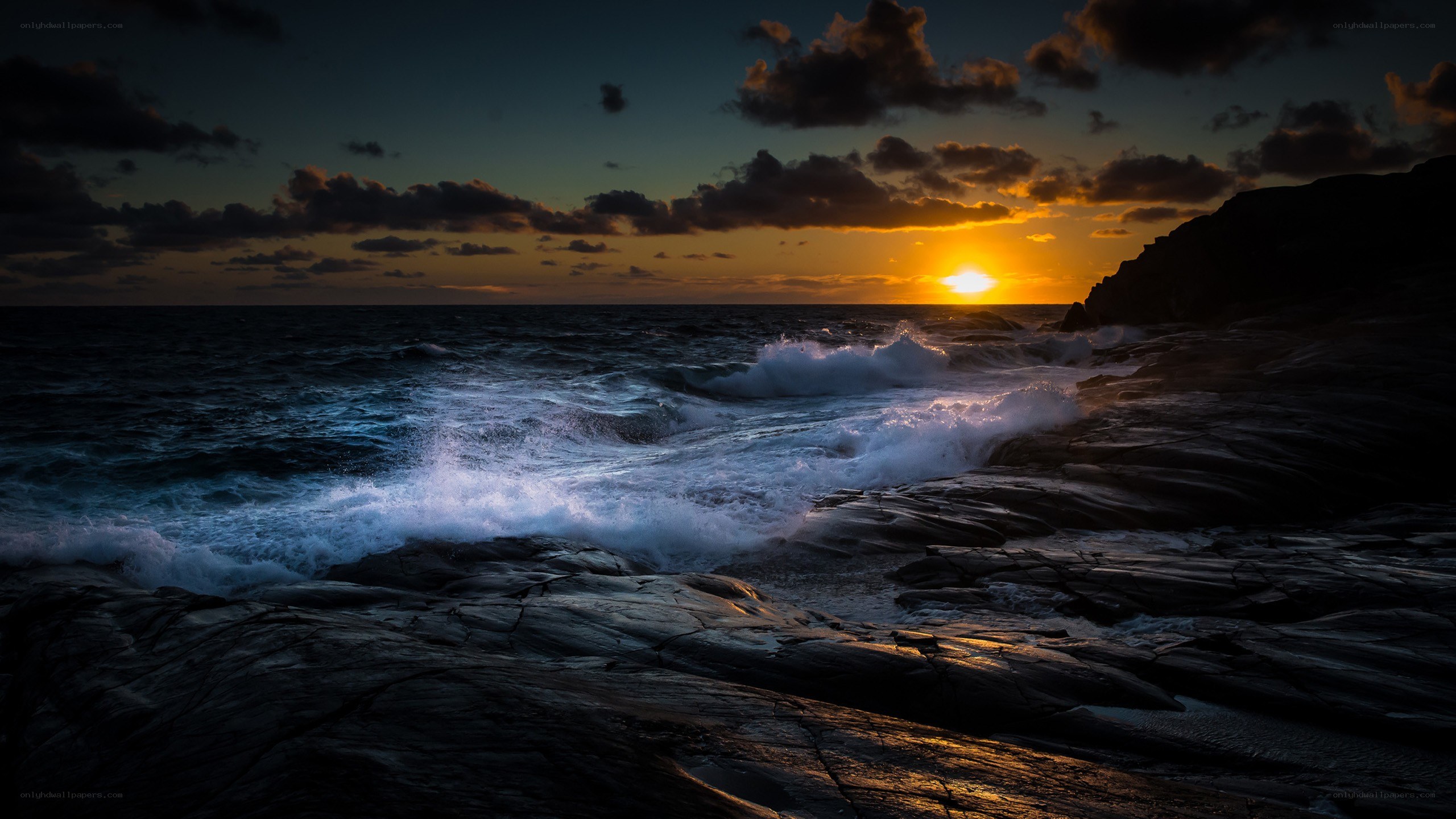 Sunset over rocky coastline