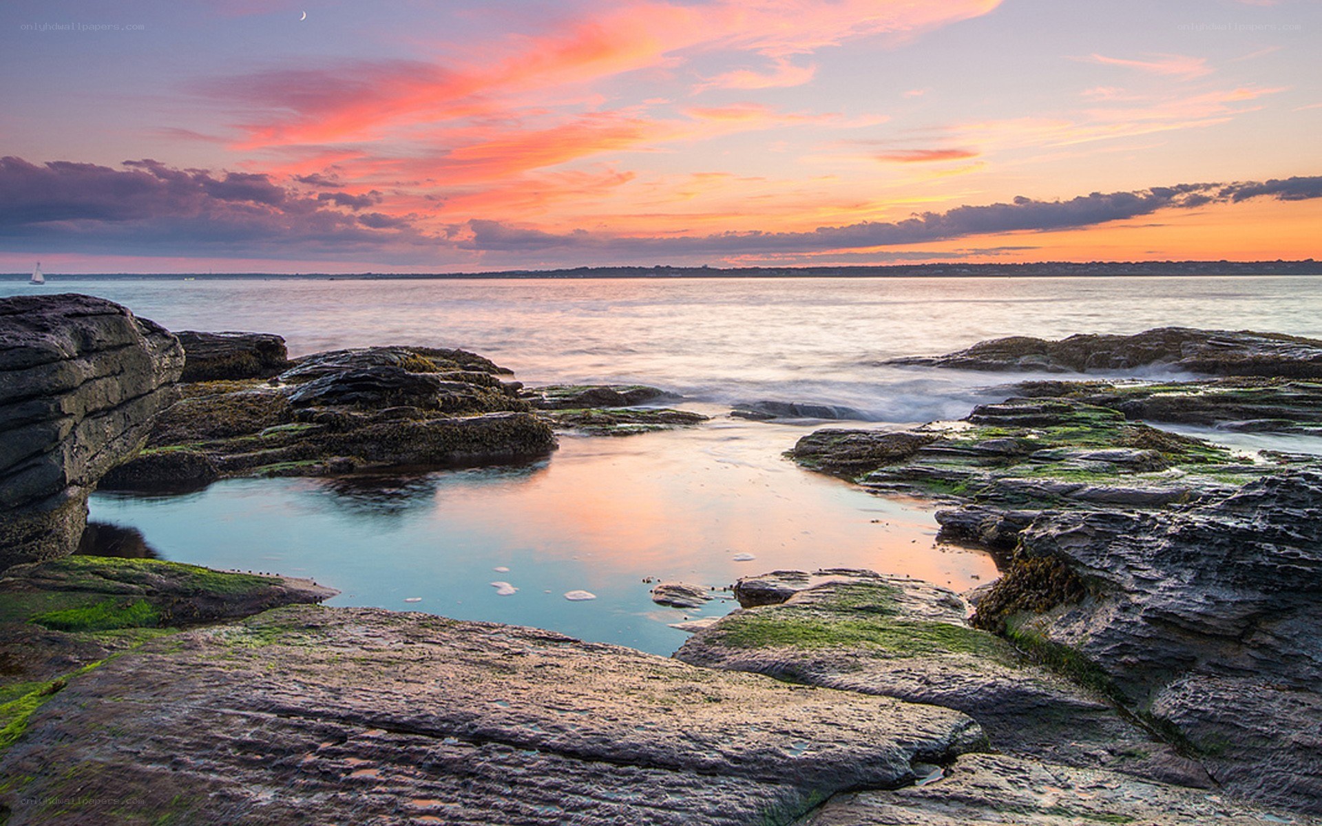 Sunset over rocky coastline