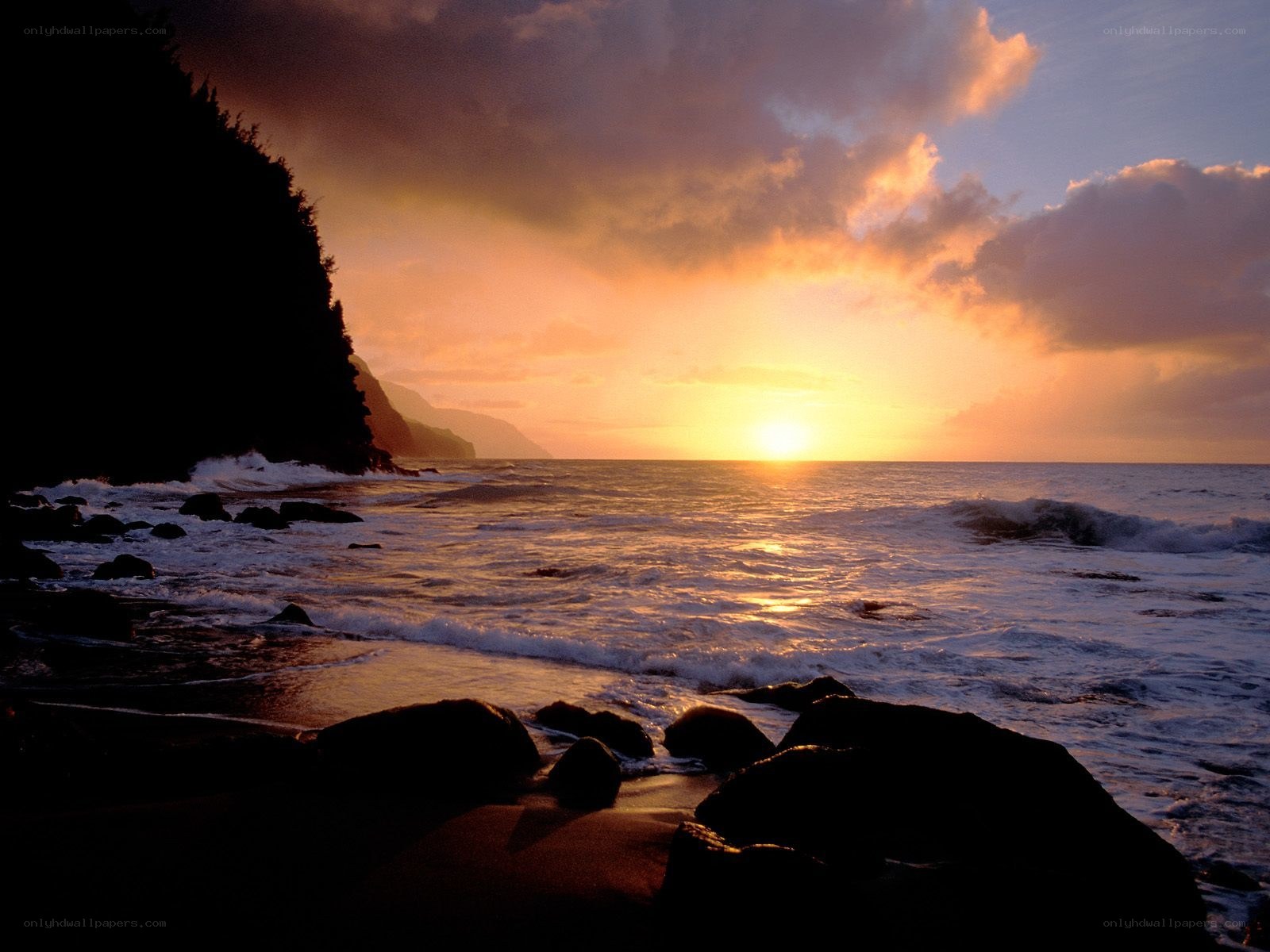 sunset over rocky coastline