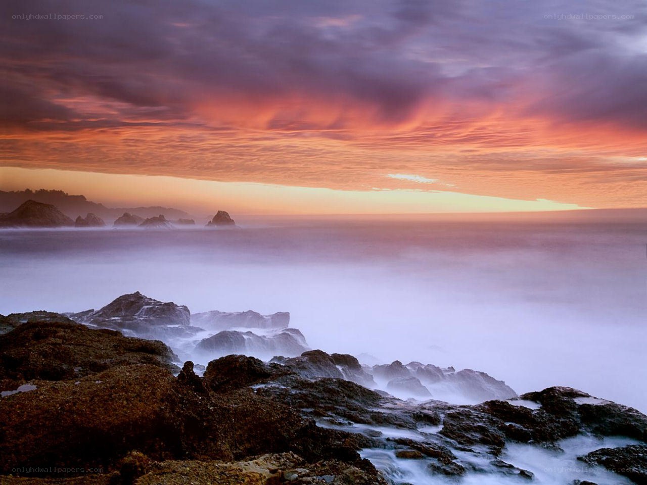 Sunset over rocky coastline