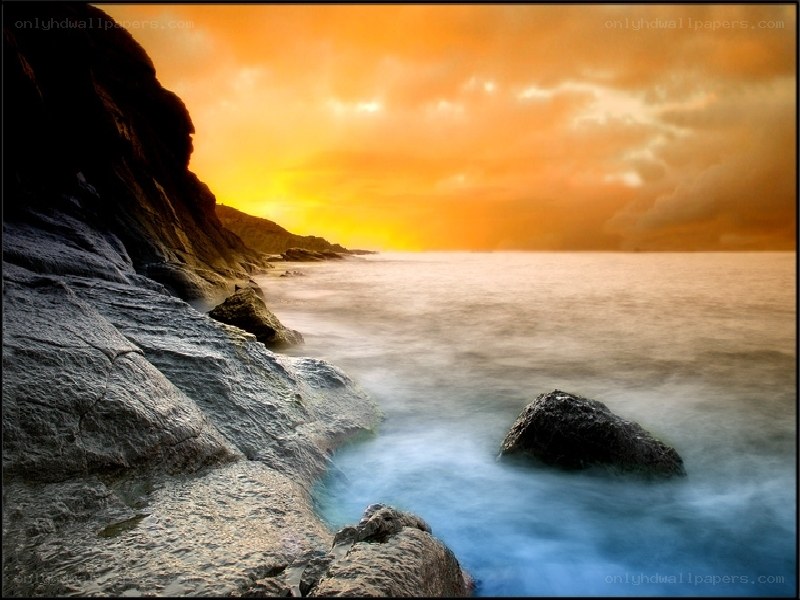 Sunset over rocky coastline