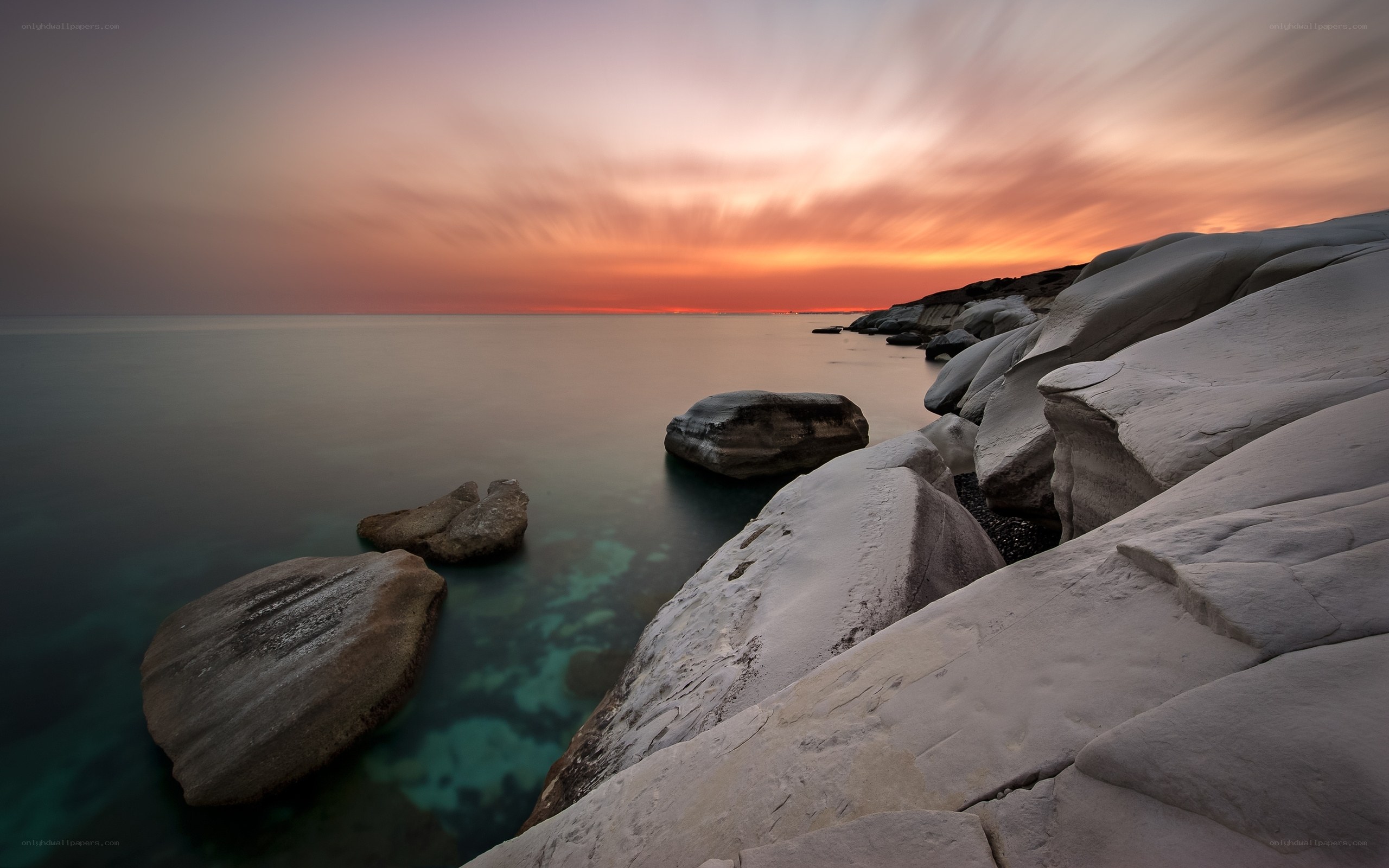 Sunset over rocky coastline