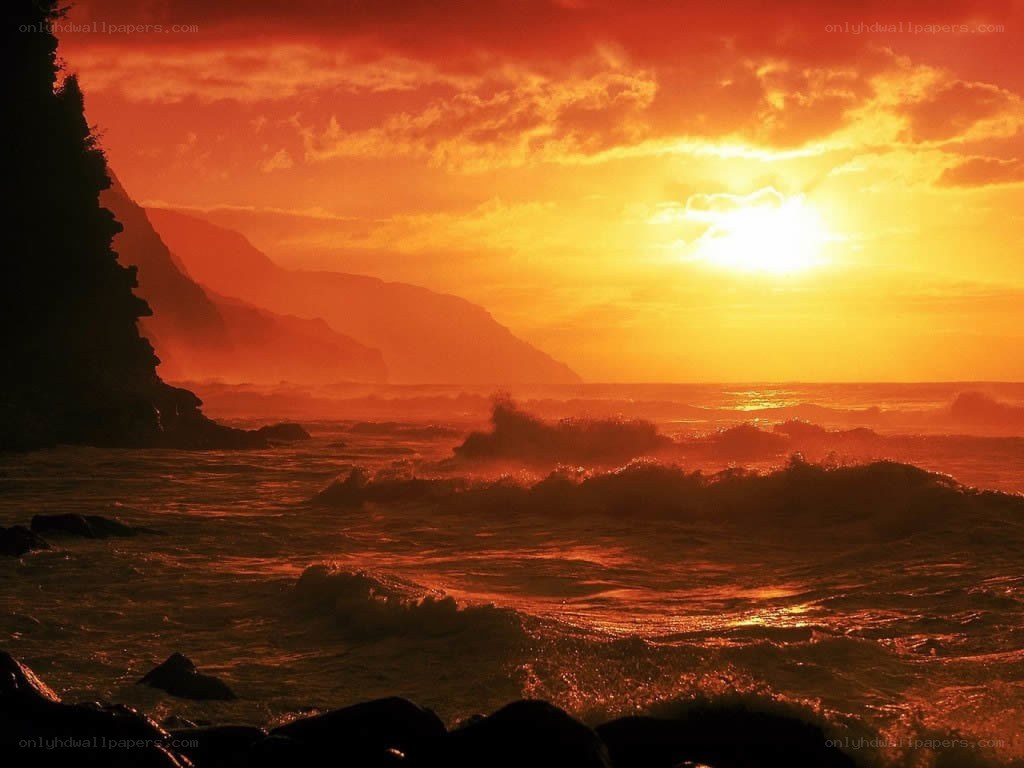 Sunset over rocky coastline