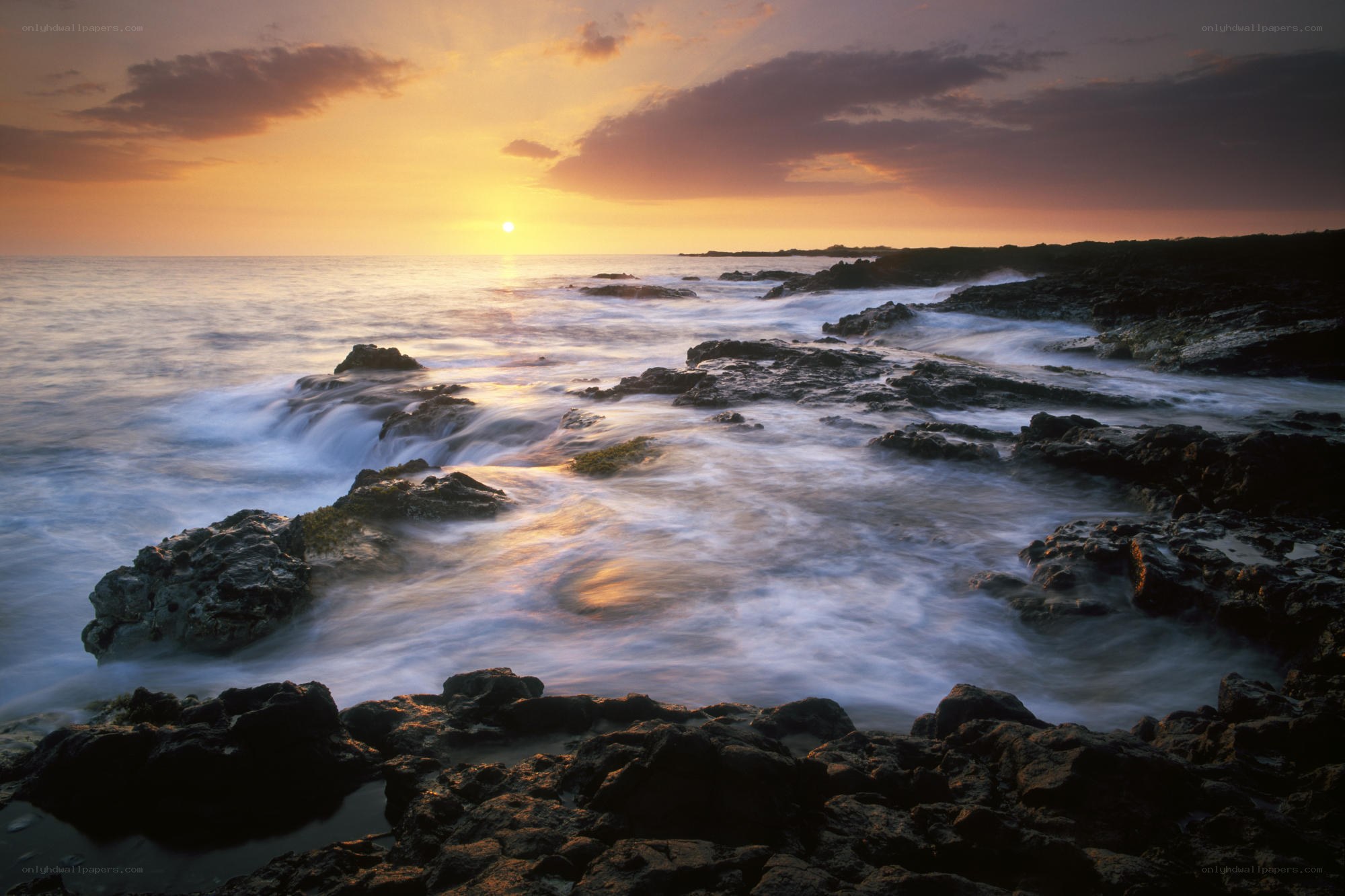 Sunset over rocky coastline