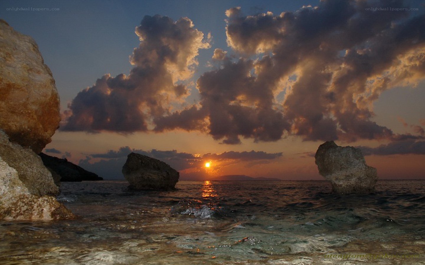 Sunset over rocky coastline