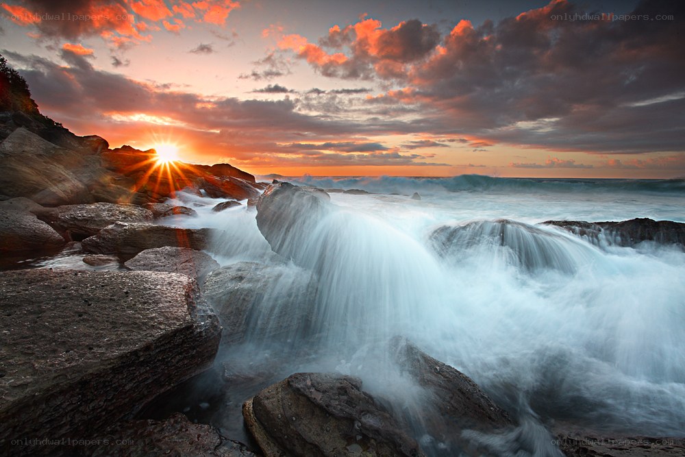 Sunset over rocky coastline