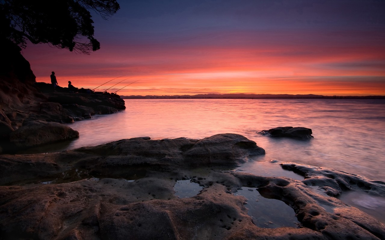 Sunset over rocky coastline