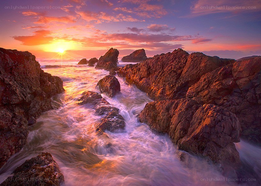 Sunset over rocky coastline