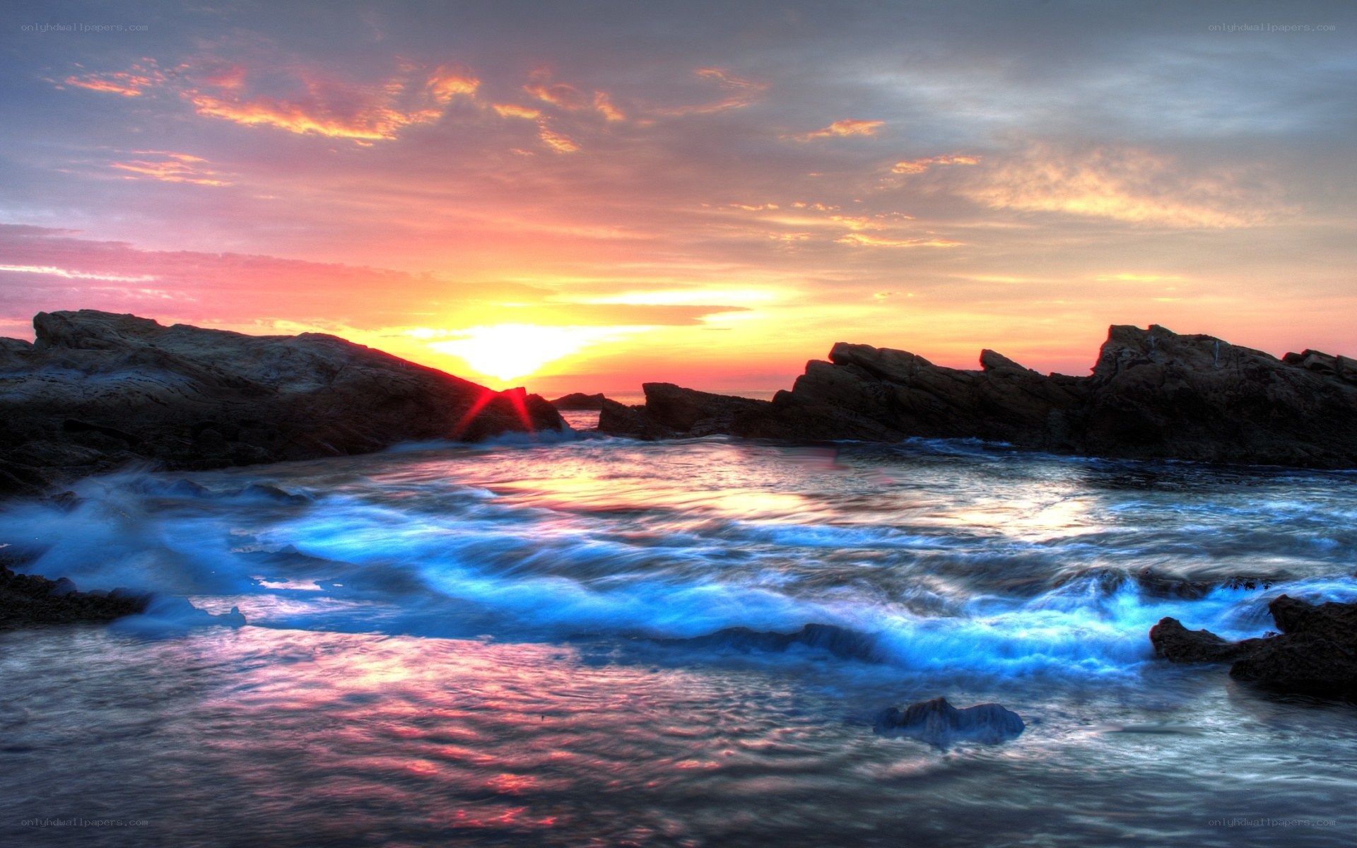 Sunset over rocky coastline