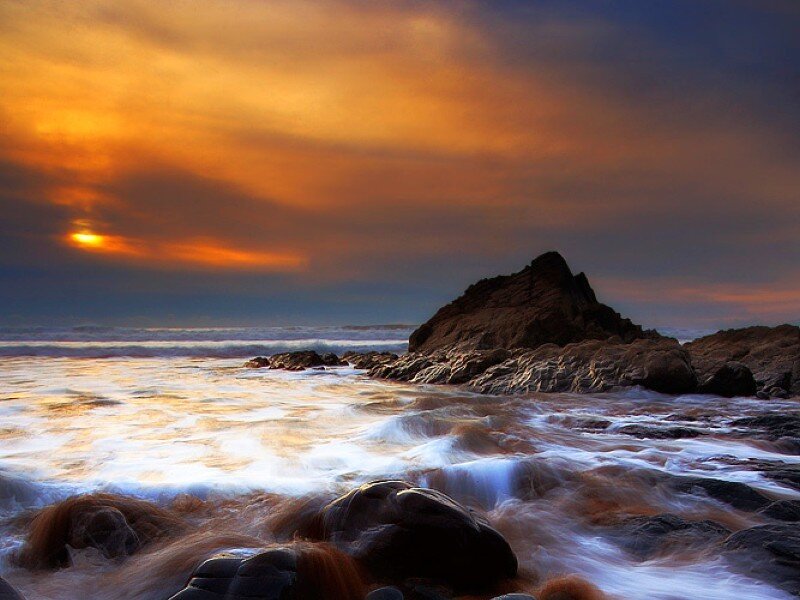 Sunset over rocky coastline