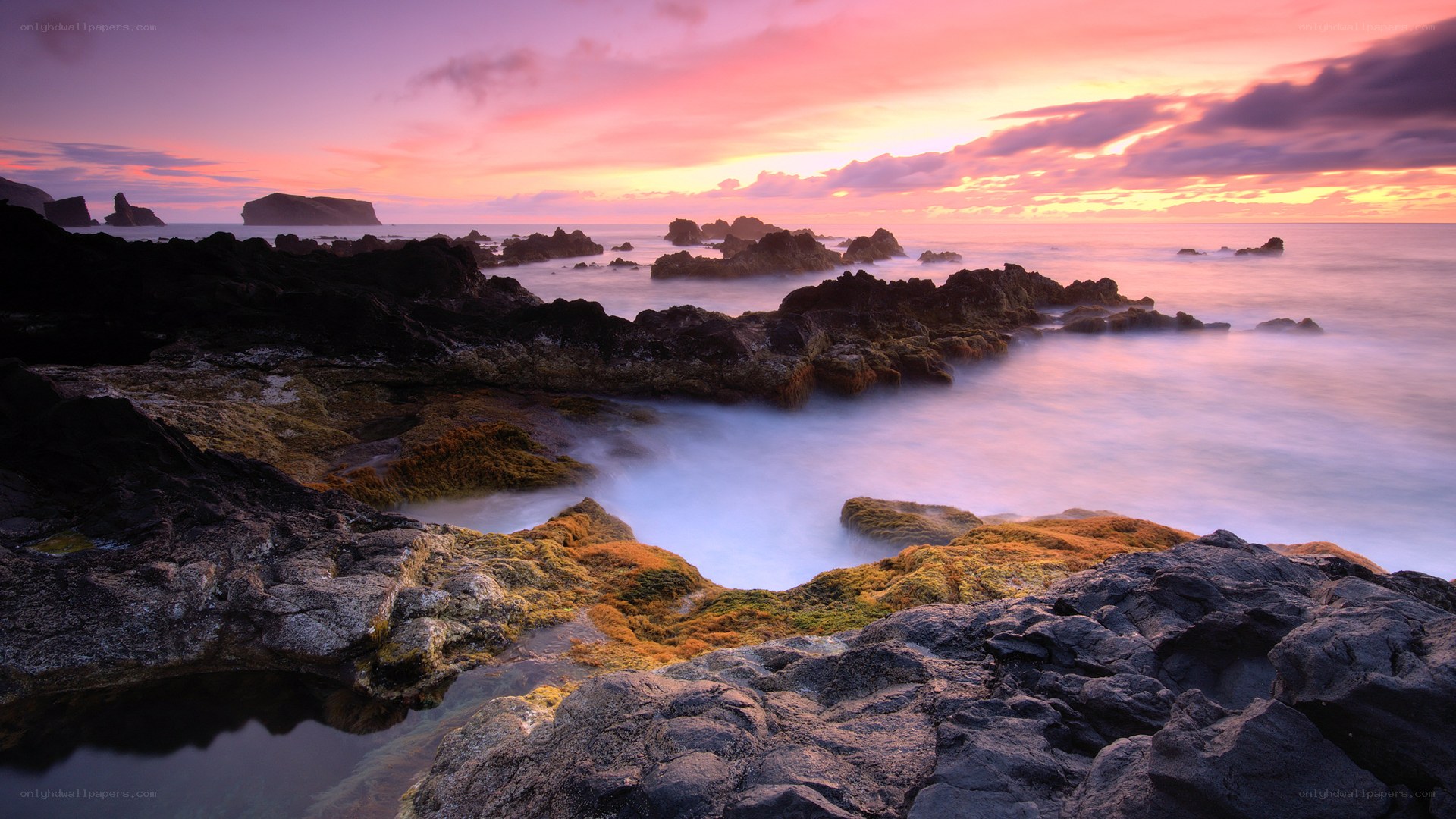 Sunset over rocky coastline