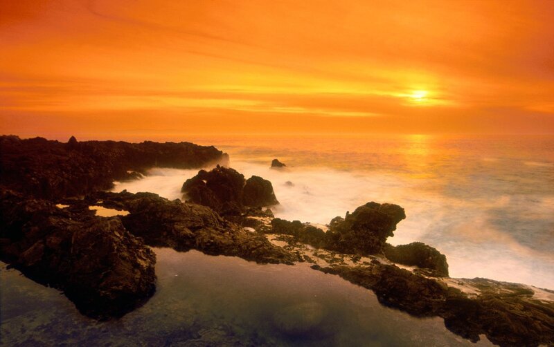 Sunset over rocky coastline