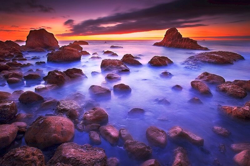 Sunset over rocky coastline