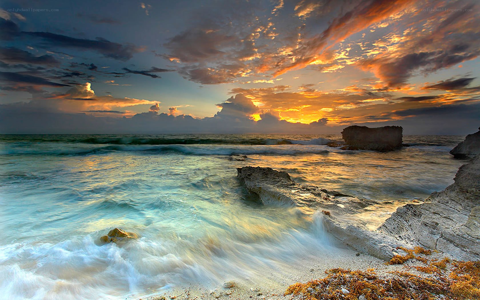 Sunset over rocky coastline