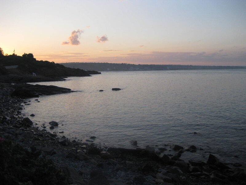 sunset over rocky coastline