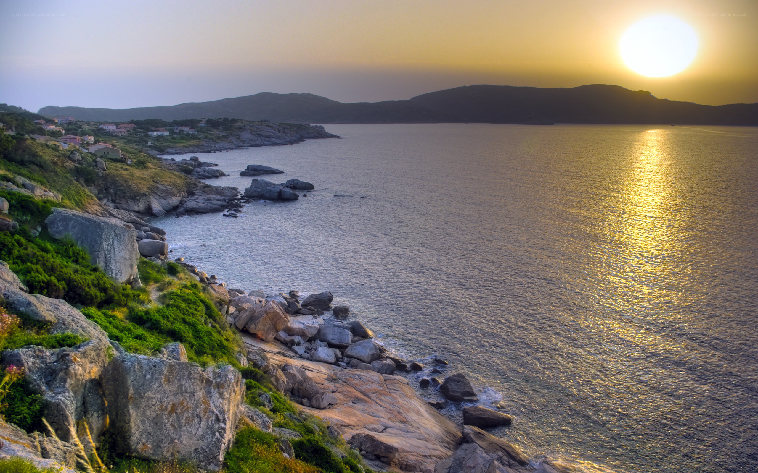 Sunset over rocky coastline