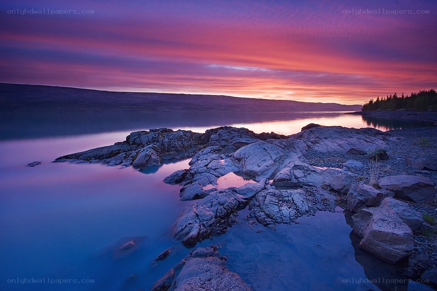 Sunset over rocky coastline