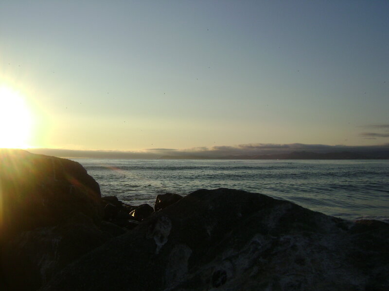 Sunset over rocky coastline