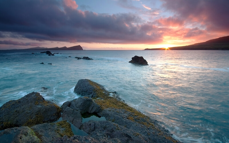 Sunset over rocky coastline