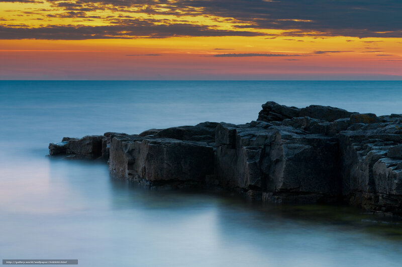 Sunset over rocky coastline