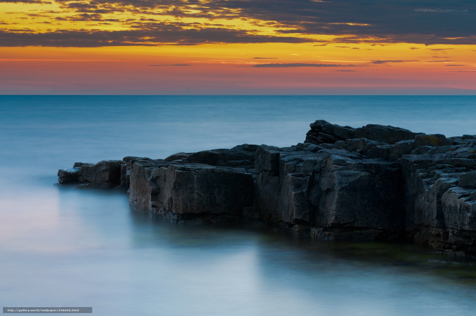 Sunset over rocky coastline